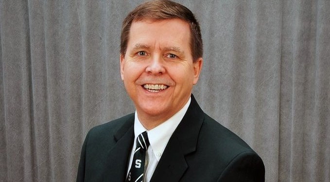 Joe Potchen, a visiting faculty member for MSU's Broad College of Business, smiling into the camera wearing a business suit and tie.