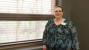 Kristi Kirkpatrick, MS in Management, Strategy and Leadership grad, standing and smiling in front of a window.