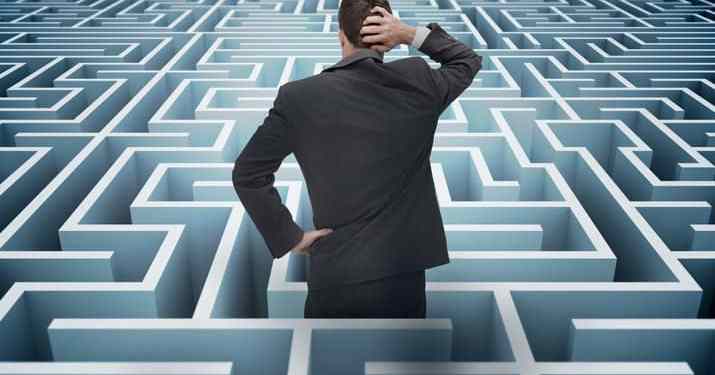 Concept of project management challenges. Confused businessman in a maze