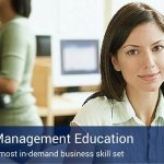 A woman working in a computer lab to become a project management professional.