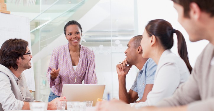 A female business leader addresses her team during a meeting