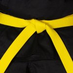 A black karate uniform with a yellow belt.