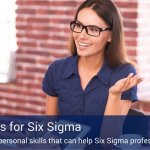 A businesswoman wearing glasses talking to a man about the soft skills that are important for six sigma professionals.