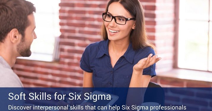 A businesswoman wearing glasses talking to a man about the soft skills that are important for six sigma professionals.