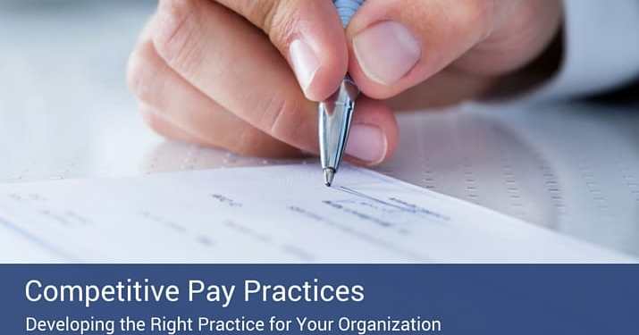 Close up of a hand signing a salary contract with a pen.