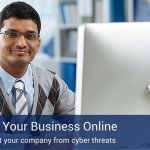 A man sitting at a computer with a blue sign on the bottom on the picture that says "Securing Your Business online".