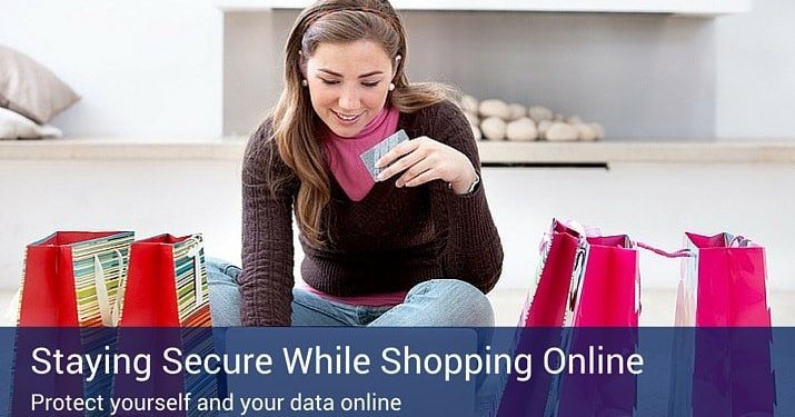 A woman sitting on the ground with four separate shopping bags, holding the credit card she just used to purchase the products.