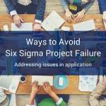 A table full of people sitting around it with office supplies, computers, and coffee scattered around the table with a blue banner at the bottom of the image that reads "Ways to Avoid Six Sigma Project Failure".