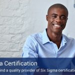 A man on his laptop looking into the camera, while earning his six sigma certification..