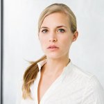 A headshot of a business woman working as a federal contract manager.