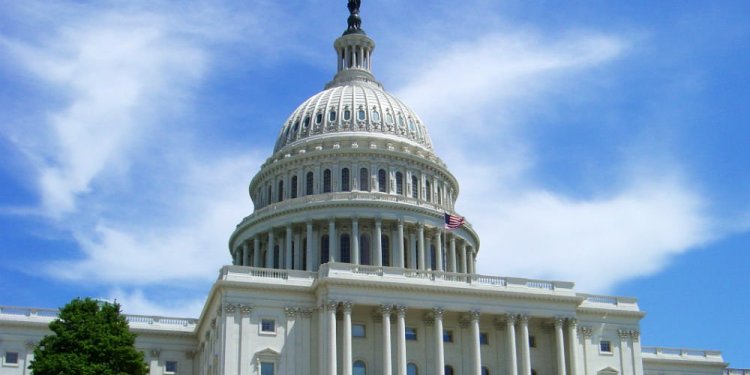 The State Capitol building against the backdrop of a clear, blue sky.