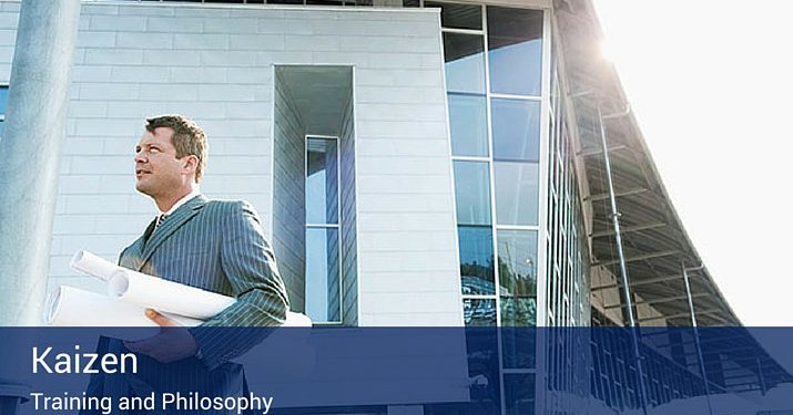 A man holding a bunch of rolled up papers in front of an office.