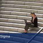 A woman sitting outside on a big flight of concrete steps on her computer. At the bottom of the picture that says "Lean Six Sigma -Training".