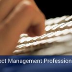 Hands typing on a computer keyboard with a blue banner across the bottom of the image that reads "The Project Management Professional - certification".