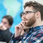 A room of students listening to a lecture.