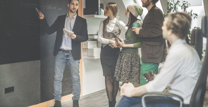 An Agile Product Owner leads a standup meeting with their Agile team