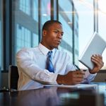 Business professional looks over the details of a contract before signing it.