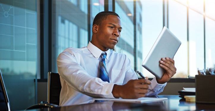 Business professional looks over the details of a contract before signing it.