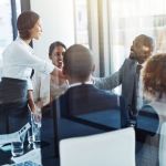 Contracting parties shake hands during a post-award kickoff meeting