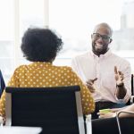 Smiling business people having a meeting in an office.