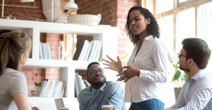 African-american manager communicating a message to her team in an office.