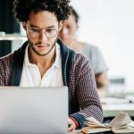 African American male concentrating on a laptop