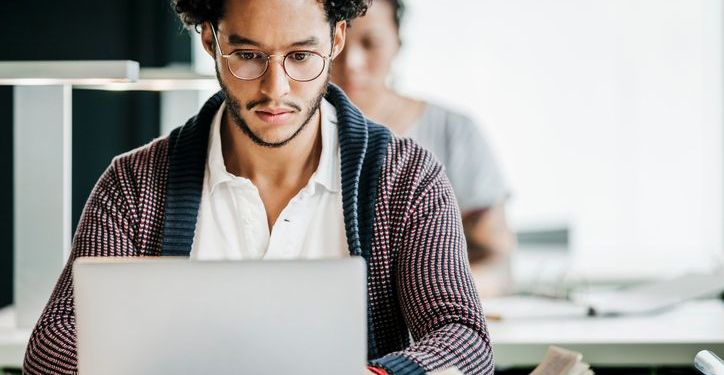 African American male concentrating on a laptop