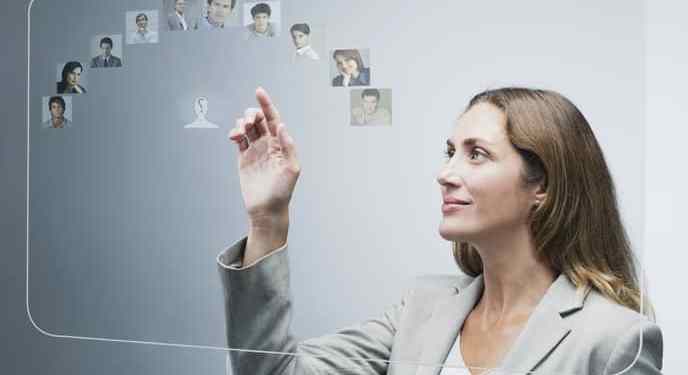 Human resources manager assessing candidates on advanced touch screen interface