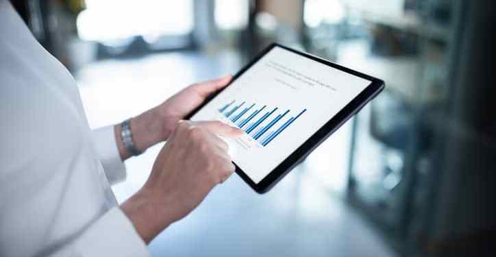 Close up of a business report on digital tablet