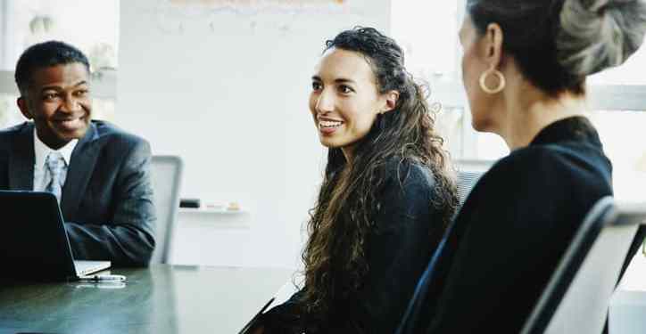 Diverse, inclusive group of office employees having a discussion.