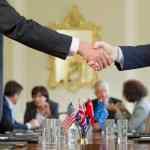 Public administrators shaking hands in meeting
